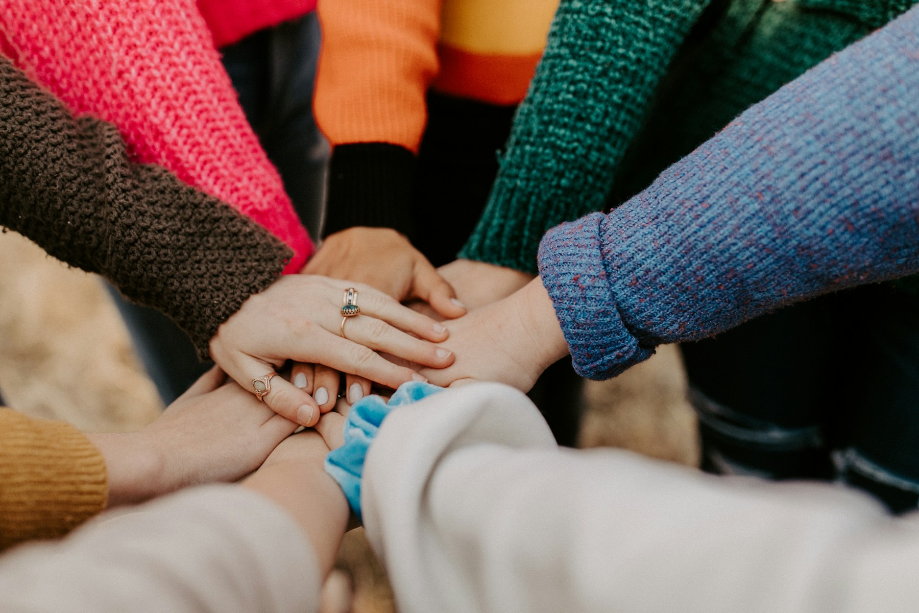 Community members joining their hands during a gathering